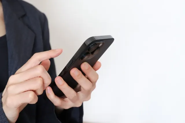 スマートフォンを手に持っている人